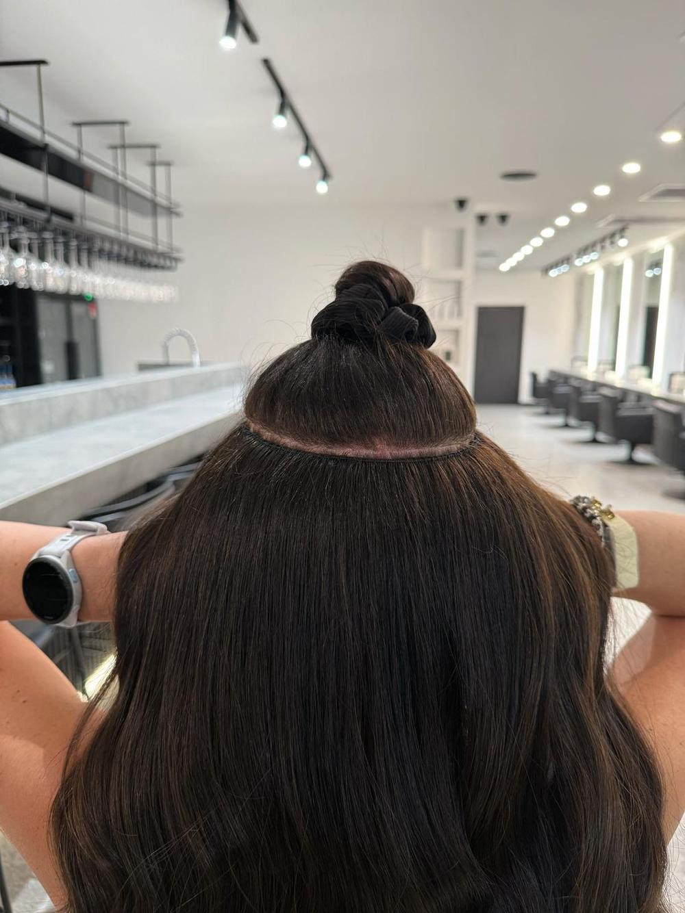 Hair tied up with the row sitting flat and undetectable